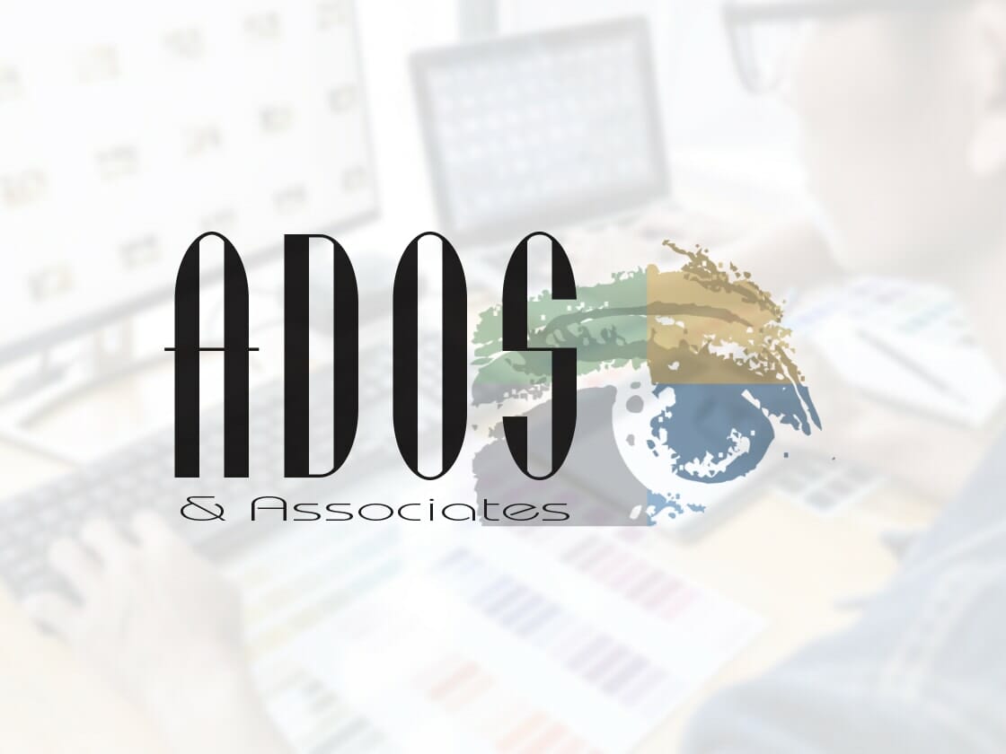 A person works at a desk with computer screens in the background displaying various color palettes. The foreground features a prominent "ADOS & Associates" logo, with "ADOS" in large black text and "& Associates" in smaller text below. The logo includes a colorful, abstract design.