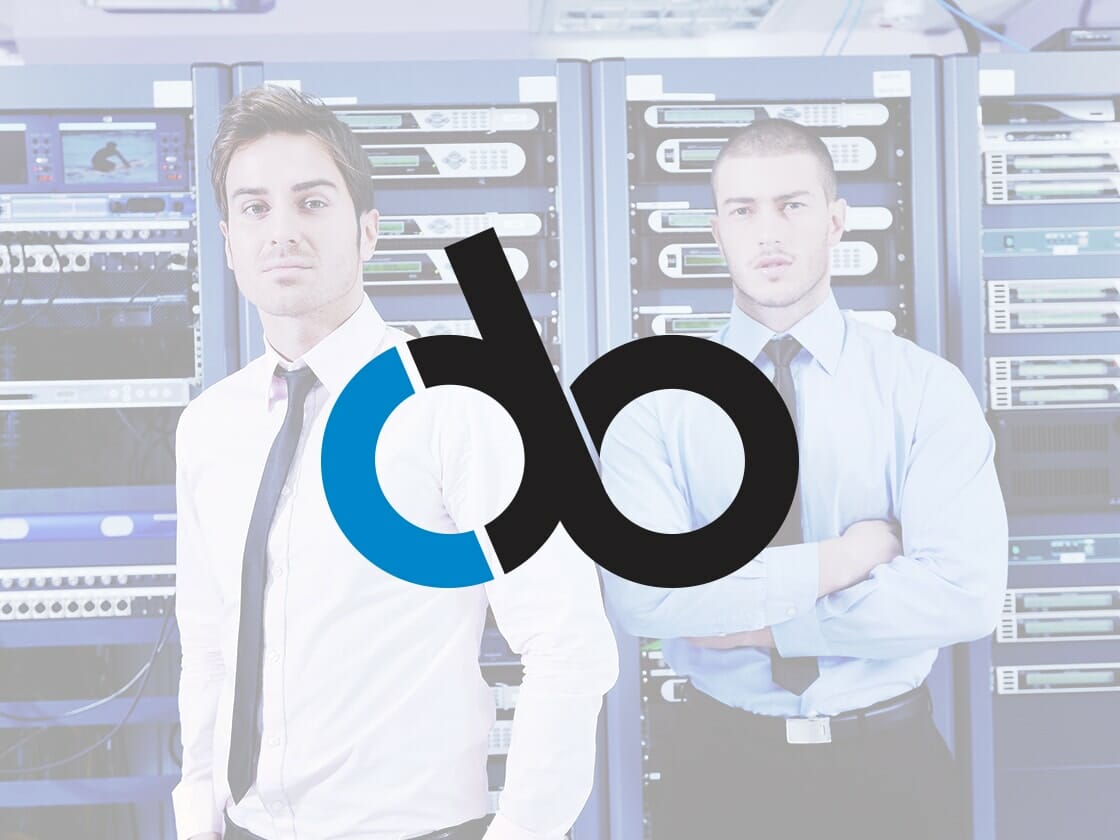 Two men wearing white and blue dress shirts stand in front of racks of servers in a data center. Both are looking directly at the camera. The man on the left is wearing a tie, while the man on the right has his arms crossed. A large logo with the letters "d" and "b" in black and blue overlays the image.