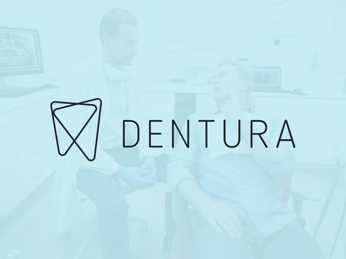 A blurred image background of a dentist in conversation with a patient sitting in a dental chair. Overlaid on the image is the logo and text "DENTURA," featuring a stylized tooth design intertwined with a heart shape. The scene takes place in a clean, modern dental office.