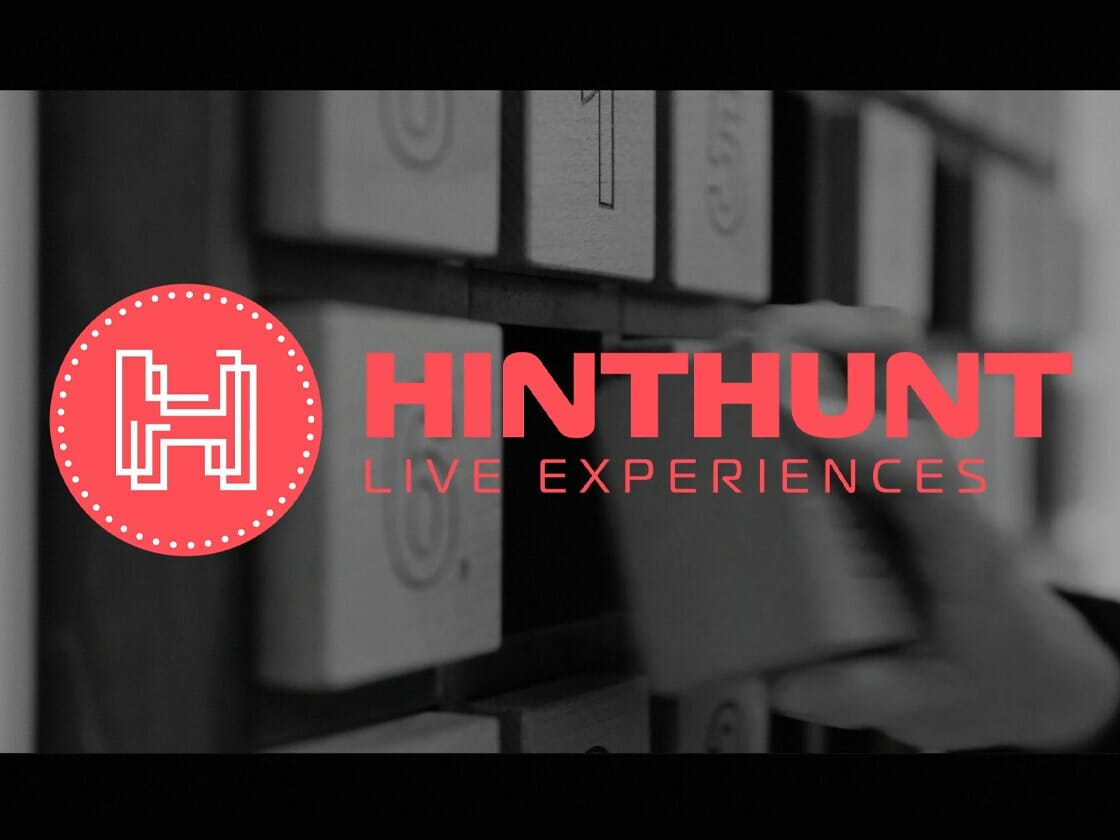 Black-and-white promotional graphic for Hinthunt Live Experiences, featuring the red Hinthunt logo and a blurred escape-room interior.