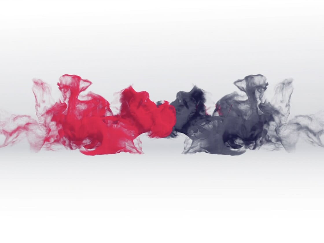 Abstract image featuring plumes of red and black ink swirling and billowing towards each other on a white background. The red ink is on the left side, while the black ink is on the right, creating a striking contrast. The inks seem to blend slightly toward the center.