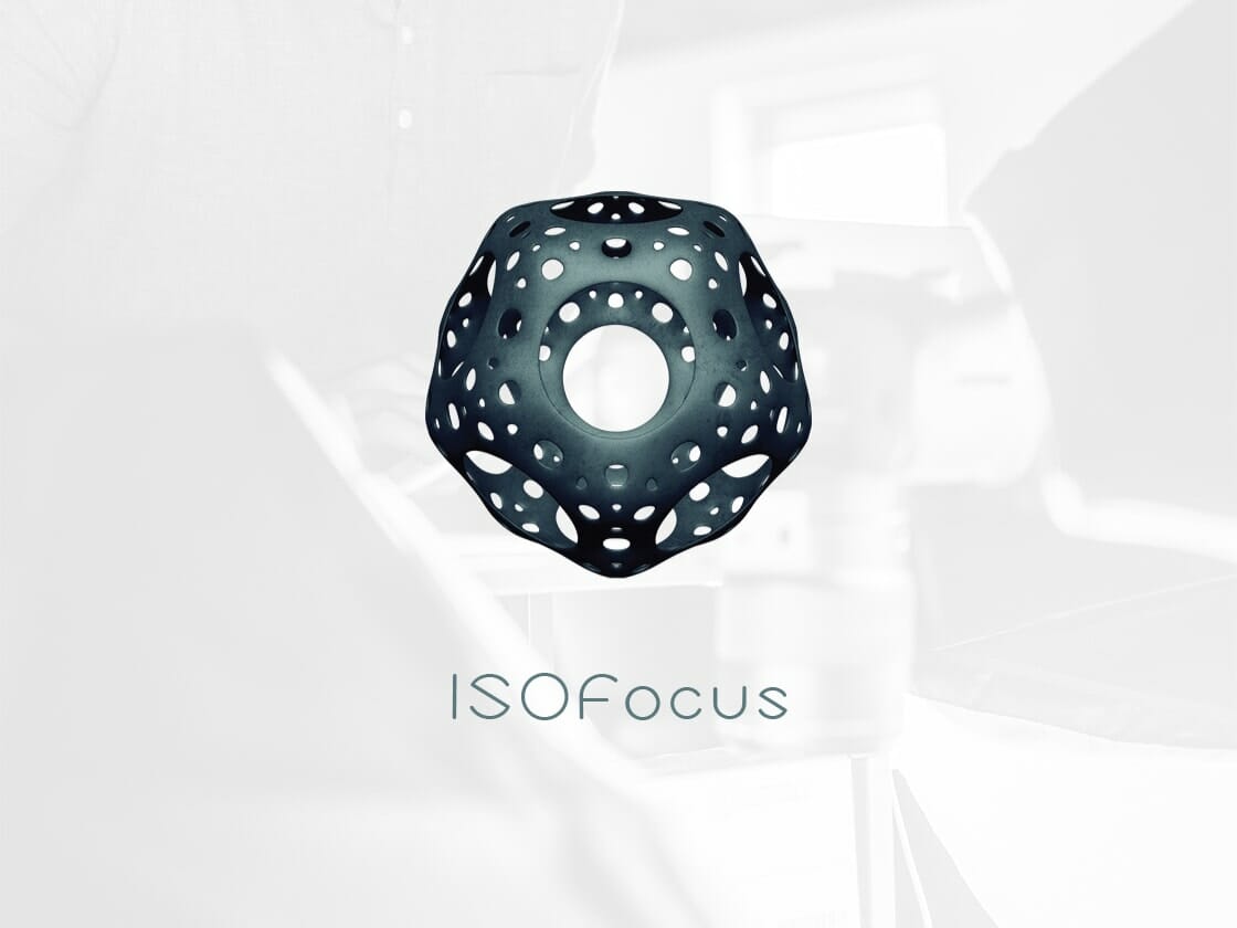 "A 3D-rendered geometric shape with multiple holes, resembling a dodecahedron, is prominently displayed in the center of a light-colored background. Below the shape, the word 'ISOfocus' is written in a modern, clean font.