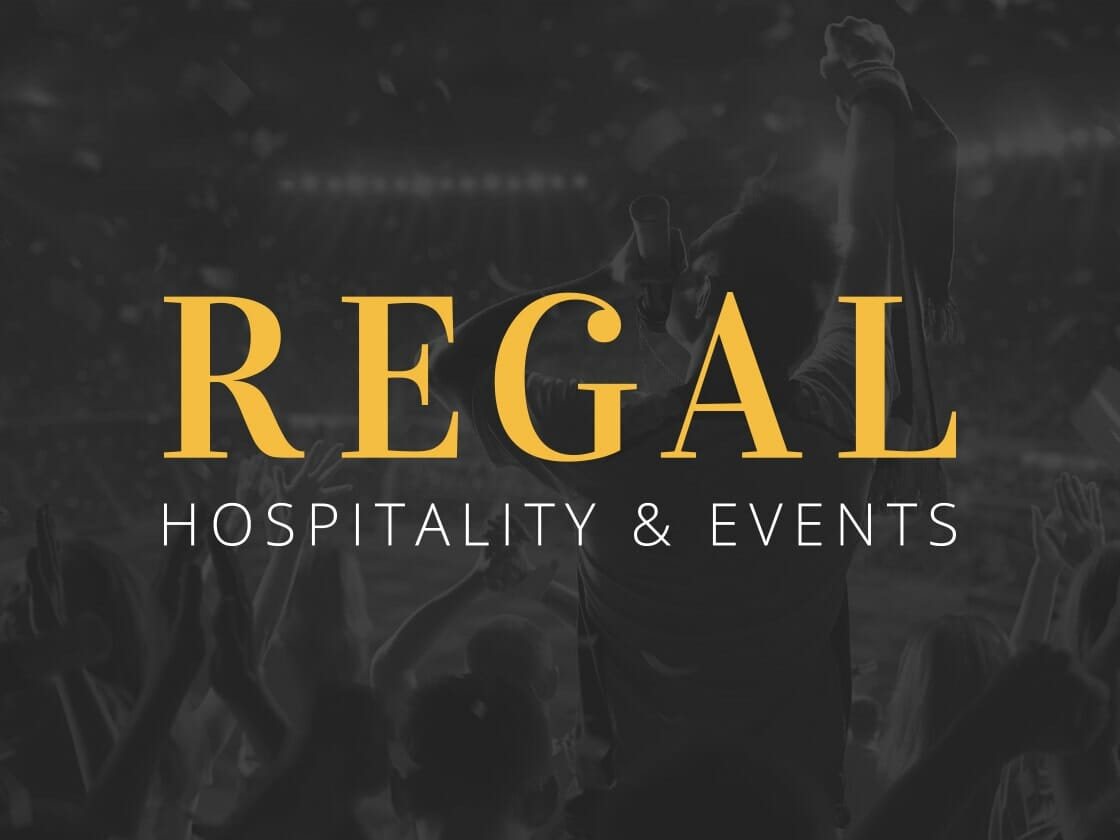A dimly lit, crowded stadium with silhouetted figures in animated poses. Bold, golden letters in the foreground read "REGAL," with smaller text below stating "HOSPITALITY & EVENTS." The atmosphere suggests excitement and celebration, with confetti-like effects in the background.