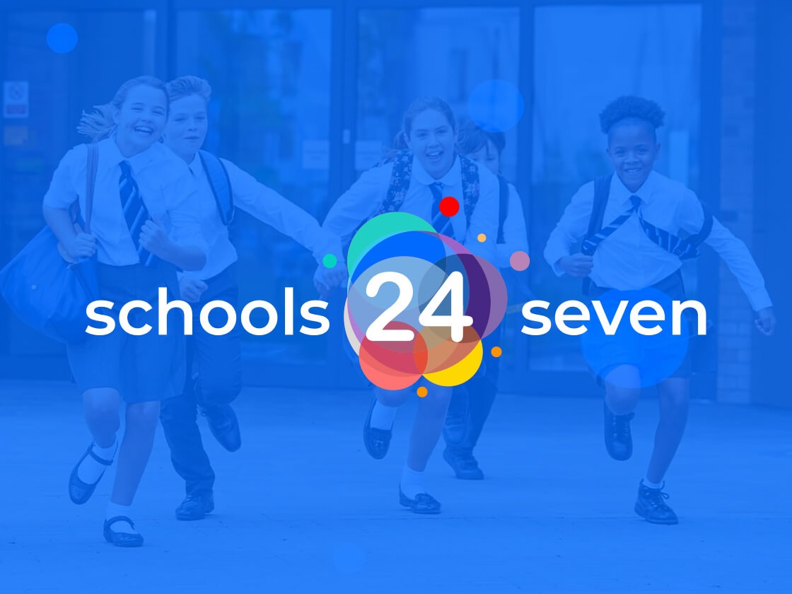 A group of five uniformed students run with enthusiasm outside a school building. Overlaid on the image is a colorful, circular logo displaying the text "Schools 24 Seven," indicating a round-the-clock educational concept. The students appear cheerful and energetic.