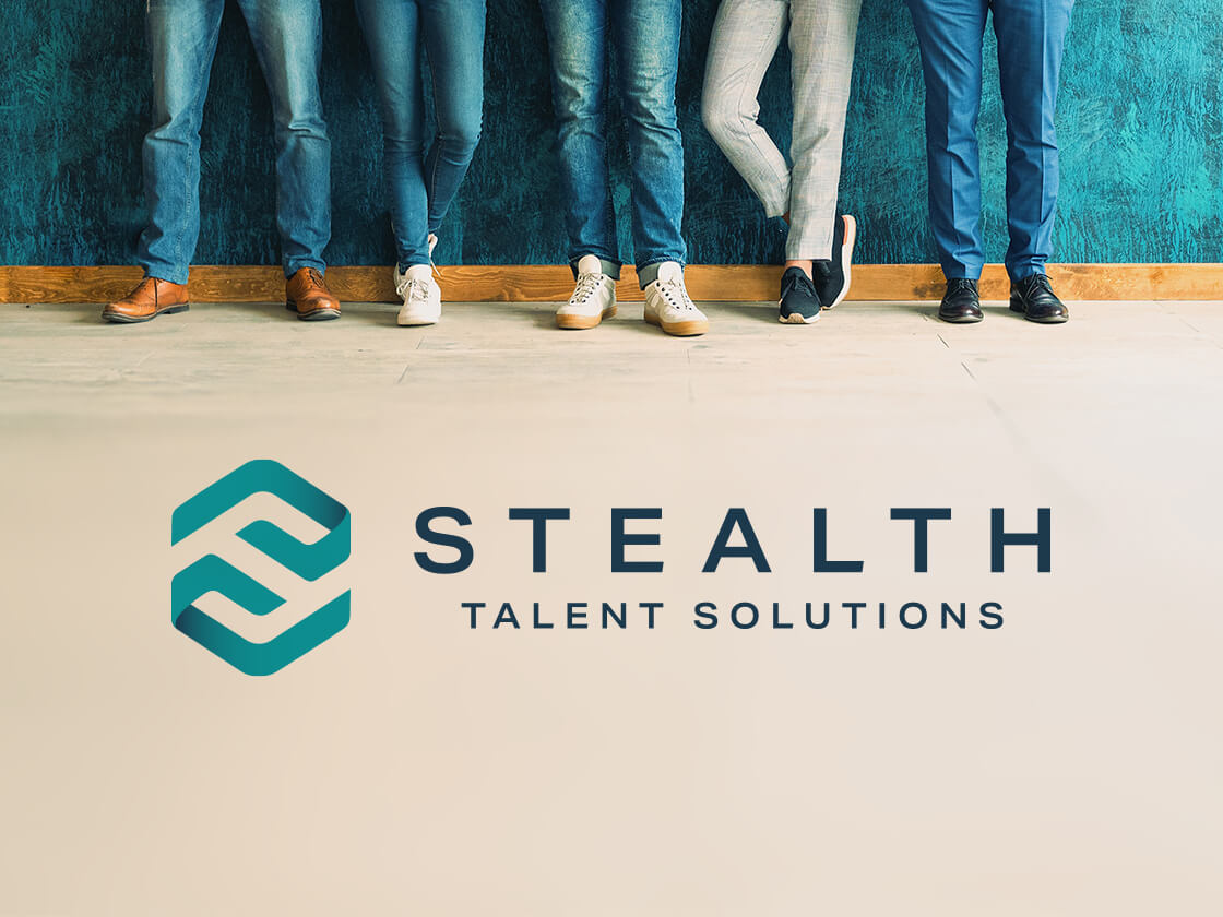 Five people stand against a teal wall, visible from the knees down. They wear various jeans and shoes, reflecting casual styles. The image foreground features a stylized logo with a teal and white emblem next to the text "STEALTH TALENT SOLUTIONS." The floor is light-colored.