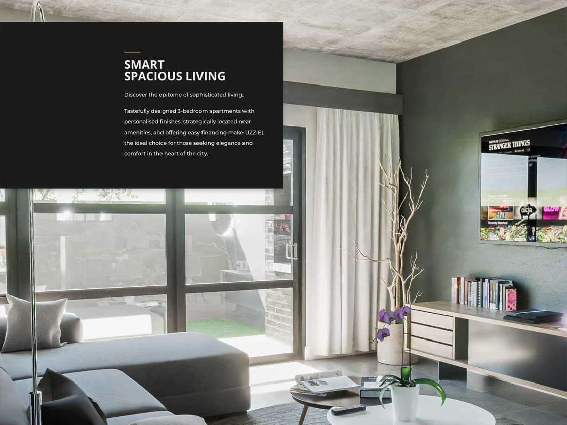 A modern living room with large windows allowing ample natural light, green and gray walls, stylish furniture including a gray sofa, coffee table with decor items, and minimalist shelves. A potted plant adds greenery. The text on the wall promotes "Smart Spacious Living by Uzziel Bryanston," perfect for showcasing on your 2024 website.