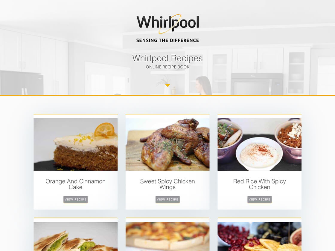 A website from Whirlpool featuring an online recipe book with various dishes like orange and almond cake, sweet spicy wings, and red rice with spicy chicken.