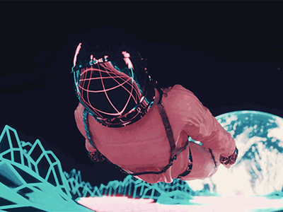 Person in virtual reality headset reaching out in a digital space with graphical elements in a video.