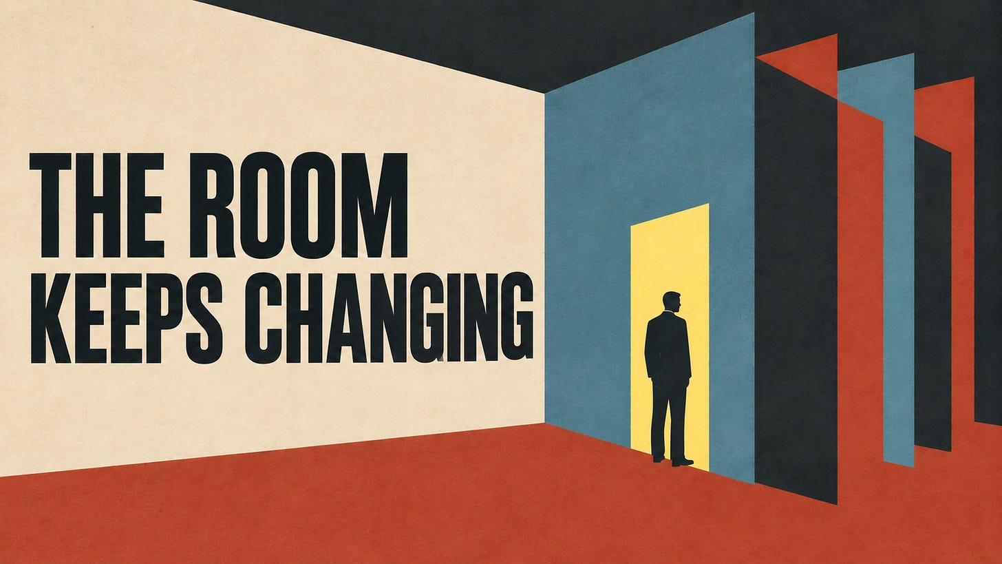 A silhouetted man stands in a yellow doorway among tall blue, charcoal and rust panels on a cream wall.