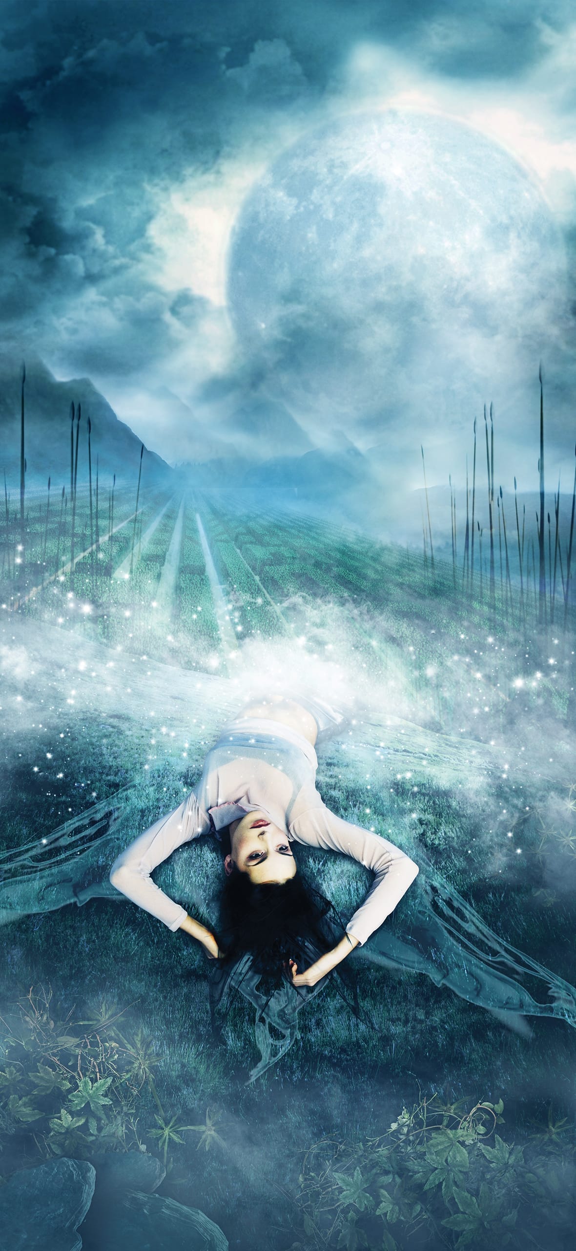 A surreal scene features a woman in a white dress lying on a grassy field under a starry sky. Her arms are behind her head, surrounded by mist. Tall grass and distant hills are silhouetted against a large, glowing full moon. The atmosphere is ethereal and dreamlike.