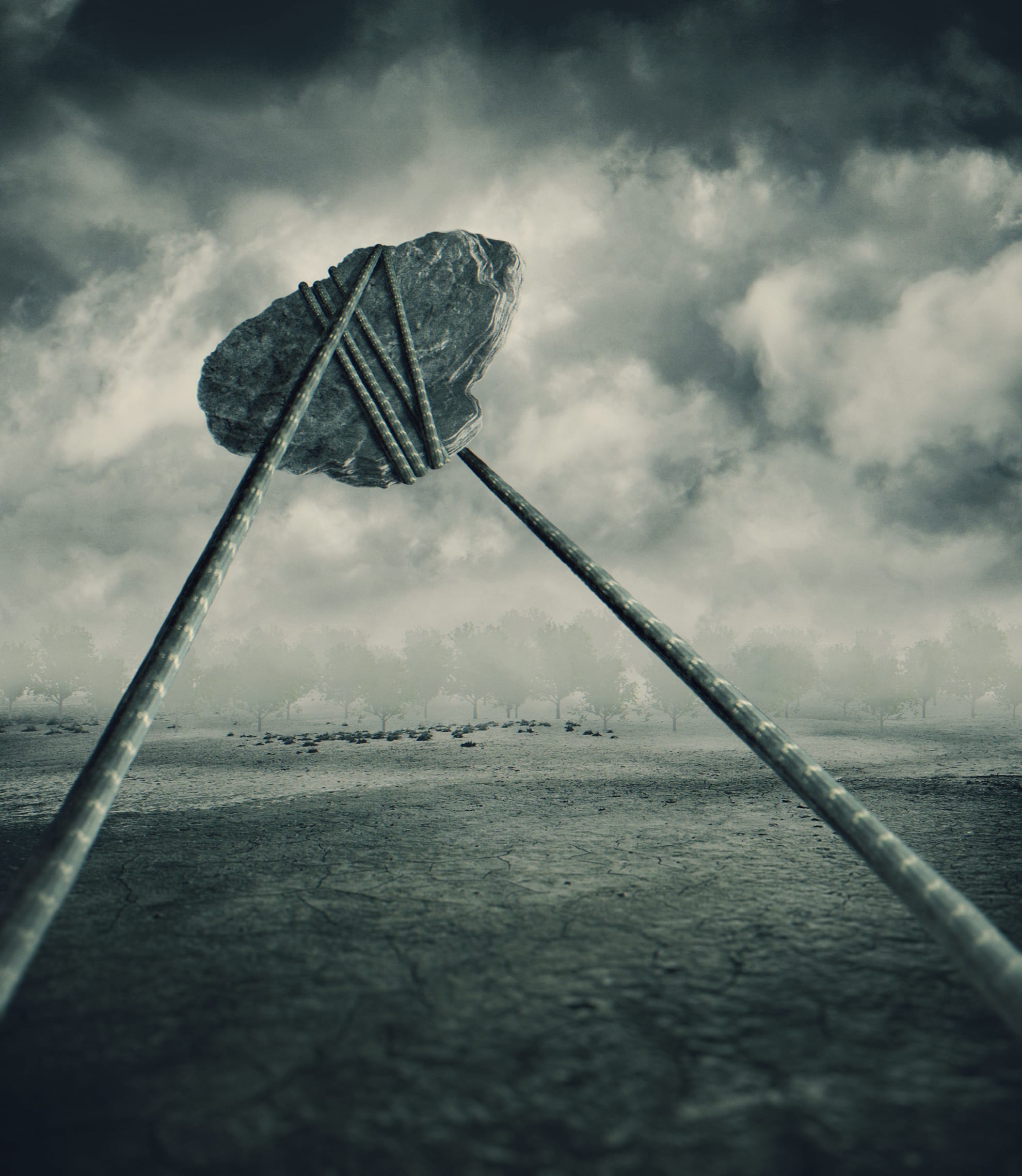 A grayish, surreal landscape features a large rock suspended on thin poles that converge below it, resembling an abstract, alien structure. The background is filled with dense, dark clouds and distant trees, creating an eerie atmosphere. The ground appears cracked and barren, as if even a kite would struggle to find life here.