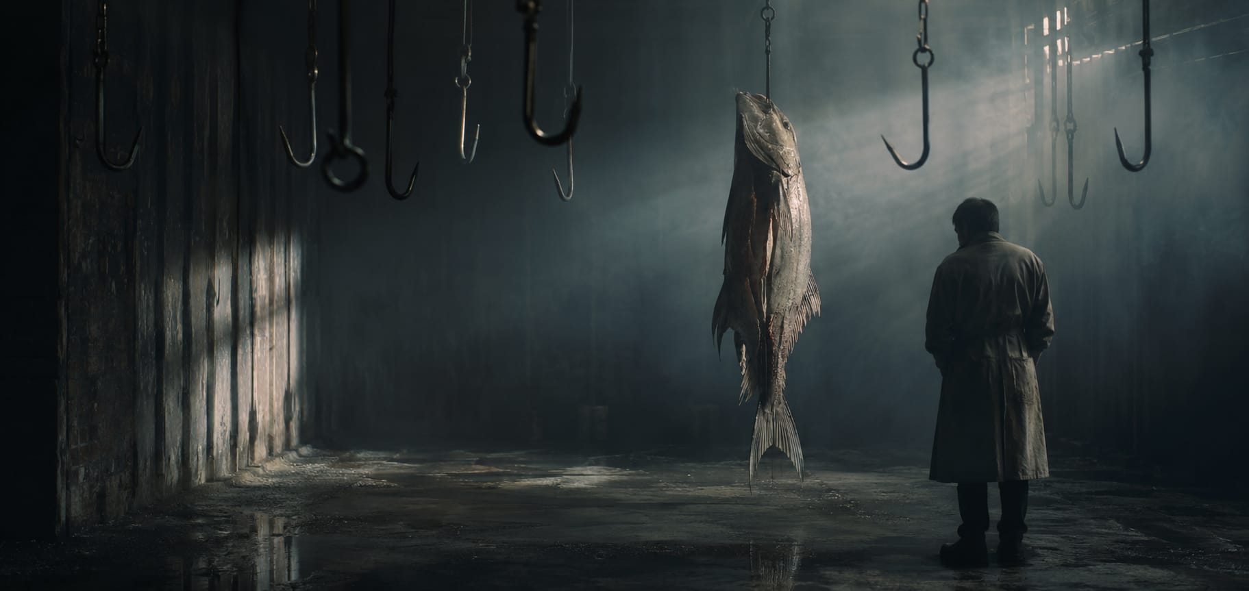 A person in a coat faces a large fish on a hook, with additional hooks hanging from the ceiling above.