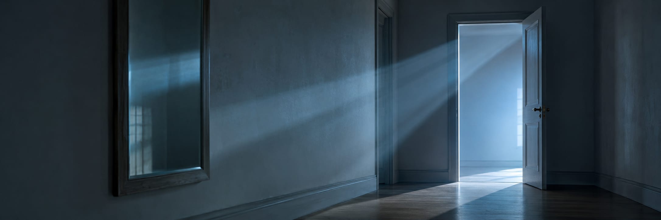Sunlight shines through a partially open door, lighting up a chaotic hallway with a framed mirror on the wall.