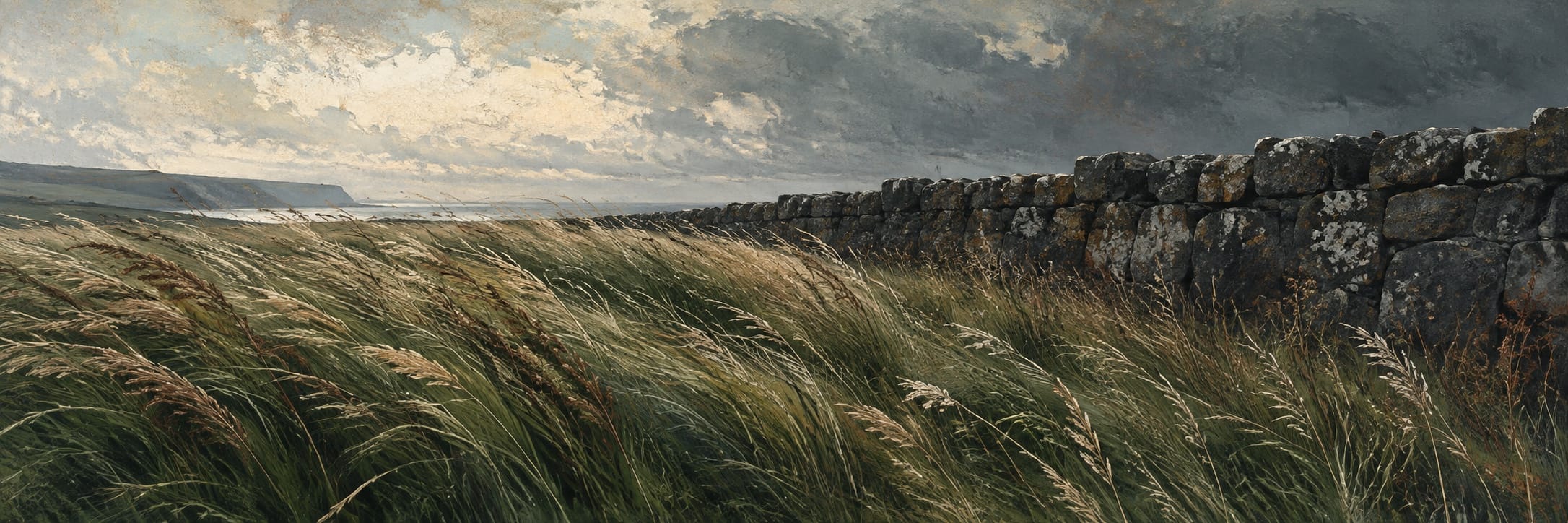 Windblown grasses meet a long dark stone wall beneath a heavy sky.